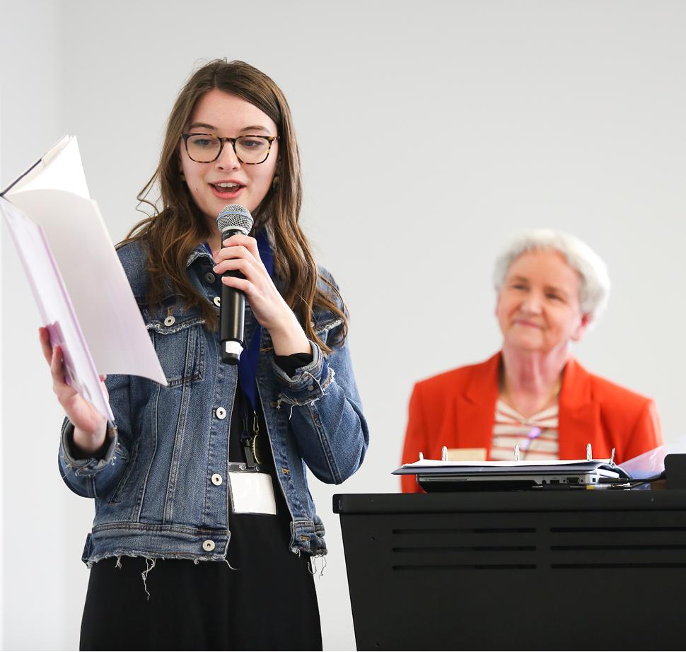 Student teacher giving presentation with microphone